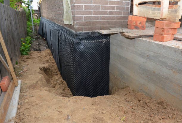 SJ Waterproofing Pros technician performing targeted Wet Basement Repair assessment in Madison, IN